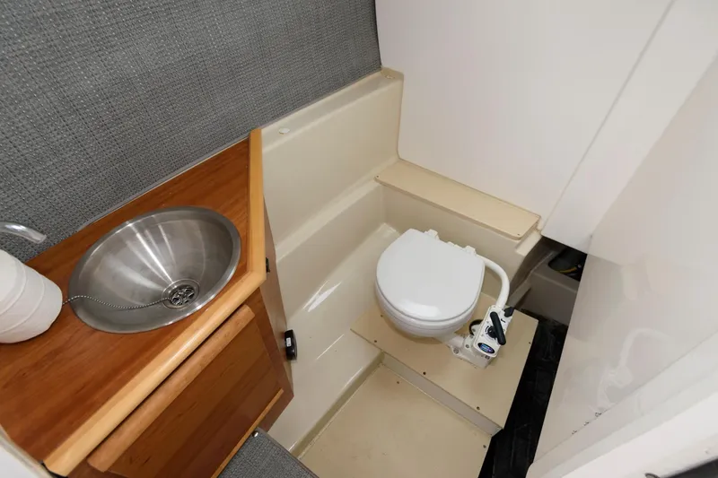 Slide: The Image of 2021 Cutwater C-24 DC boat bathroom with sink and toilet. - 21