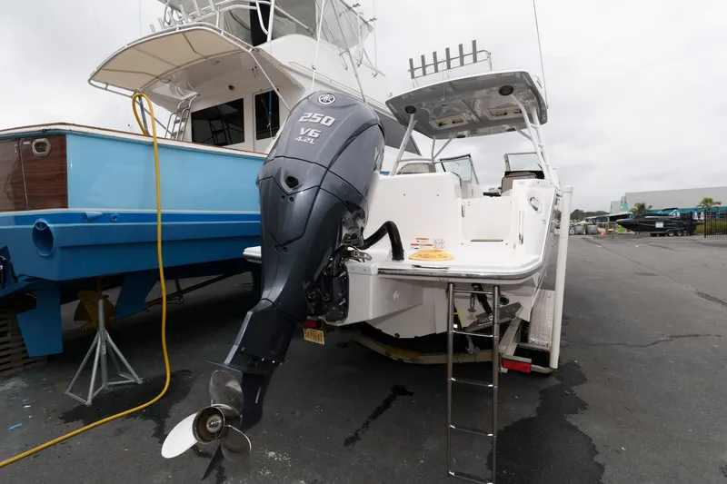 Slide: The Image of 2021 Cutwater C-24 DC boat with Yamaha 250 V6 engine, docked at marina. - 24