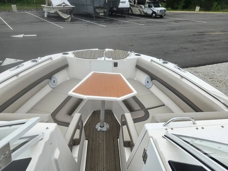 Slide: The Image of 2021 Cutwater C-24 DC boat interior with seating and table in parking lot. - 9