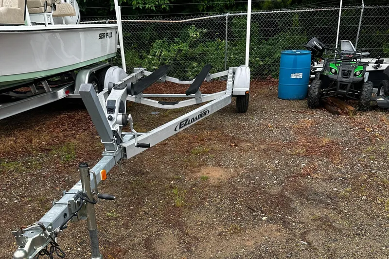 Slide: The Image of Boat trailer for 2003 Novurania 530 DL, parked near a boat and ATV. - 6