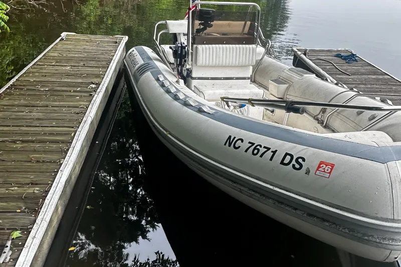 Slide: The Image of 2003 Novurania 530 DL boat docked by wooden pier. - 8