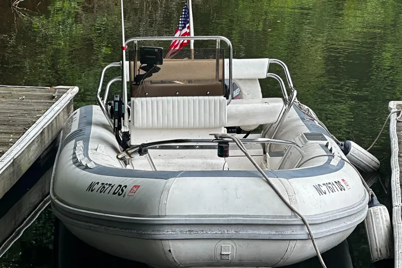 Slide: The Image of 2003 Novurania 530 DL inflatable boat docked by the water. - 9