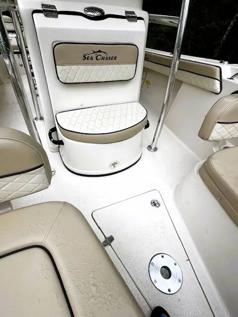 Slide: The Image of 2022 Sea Chaser 22 HFC boat interior with beige seating and sleek design. - 10