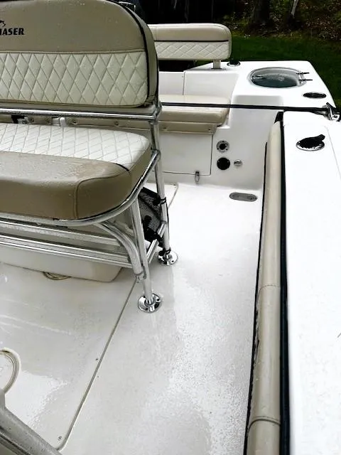 Slide: The Image of 2022 Sea Chaser 22 HFC boat interior with beige seating and white deck. - 12