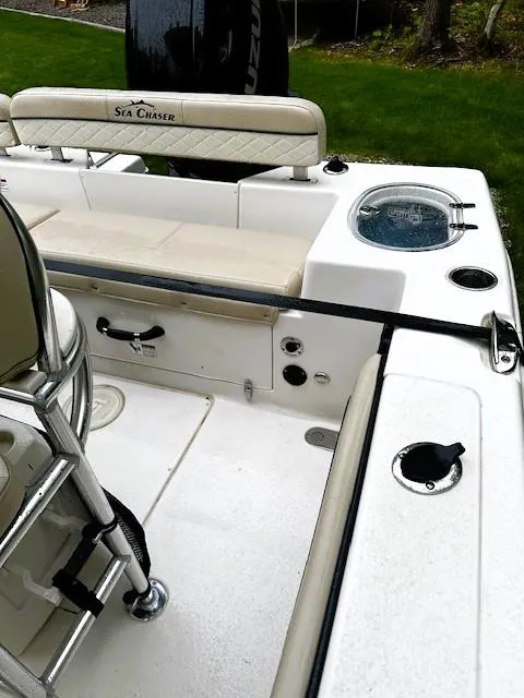 Slide: The Image of 2022 Sea Chaser 22 HFC boat interior with seating and fishing amenities. - 13