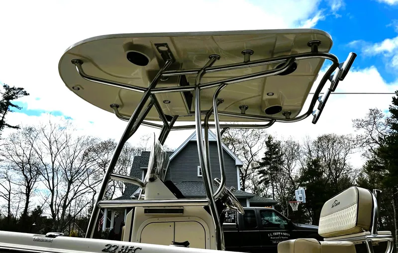 Slide: The Image of 2022 Sea Chaser 22 HFC boat with T-top and seating, outdoors. - 2
