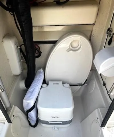 Slide: The Image of 2022 Sea Chaser 22 HFC boat interior with portable toilet and storage area. - 28