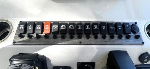 Slide: The Image of Control panel of a 2022 Sea Chaser 22 HFC boat with multiple switches. - 29