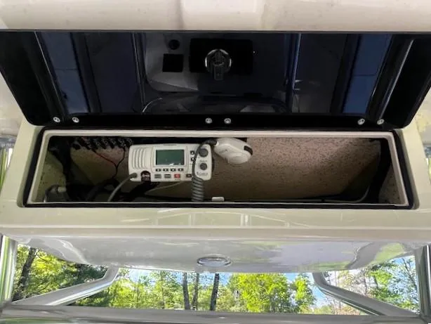 Slide: The Image of 2022 Sea Chaser 22 HFC boat console with radio equipment in storage compartment. - 30