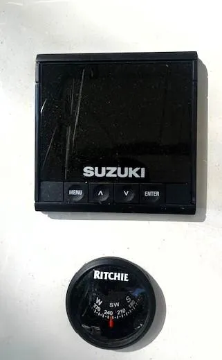 Slide: The Image of Suzuki marine control panel and Ritchie compass on a 2022 Sea Chaser 22 HFC boat. - 33