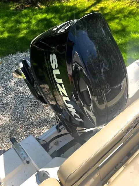Slide: The Image of 2022 Sea Chaser 22 HFC boat with Suzuki outboard motor, parked on gravel. - 38