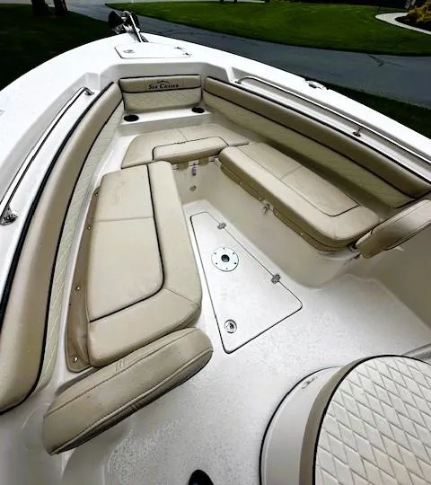 Slide: The Image of 2022 Sea Chaser 22 HFC boat interior with beige seating and storage compartments. - 9