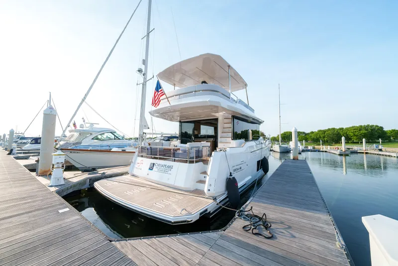 Slide: The Image of 2024 Sirena 48 yacht docked at a marina. - 2