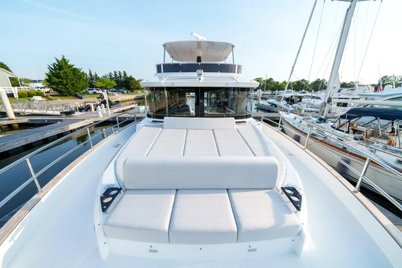 Slide: The Image of 2024 Sirena 48 yacht with spacious sun deck at marina. - 25