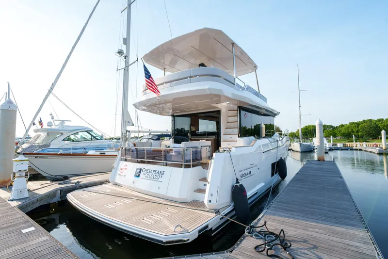 Slide: The Image of 2024 Sirena 48 yacht docked at a marina, rear view. - 3