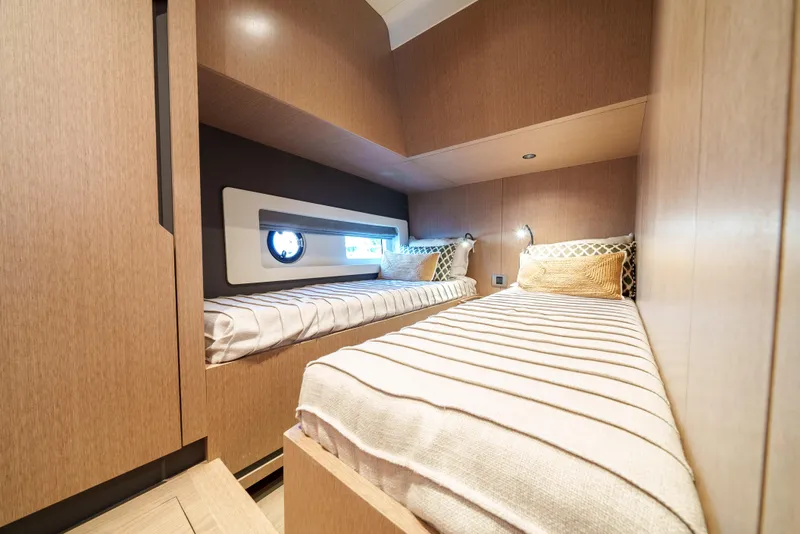Slide: The Image of 2024 Sirena 48 yacht cabin with twin beds and modern wood finish. - 39