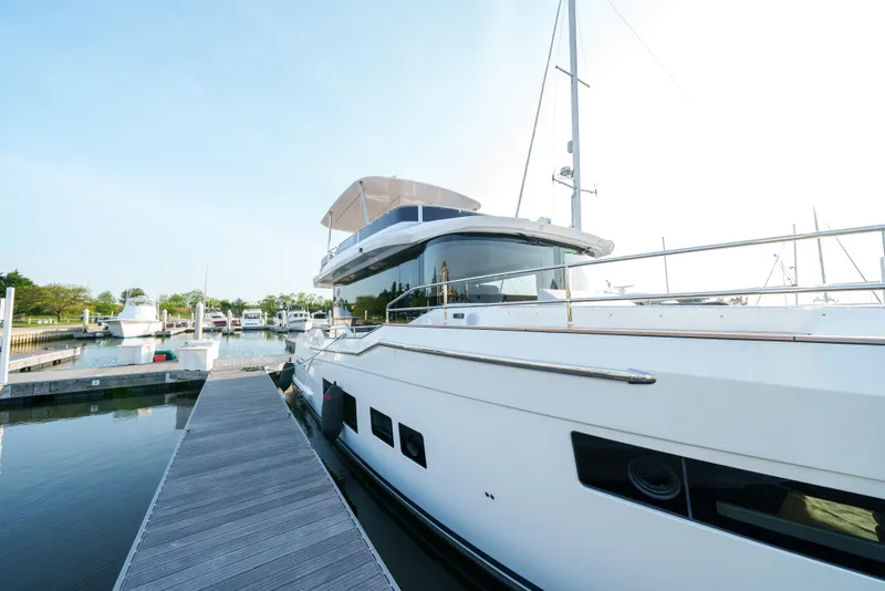 Slide: The Image of 2024 Sirena 48 yacht docked at a marina on a sunny day. - 5
