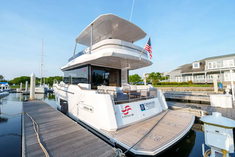Slide: The Image of 2024 Sirena 48 yacht docked at a marina, rear view. - 6