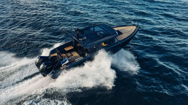 Slide: The Image of 2024 XO Boats EXPLR 10S cruising on open water. - 11