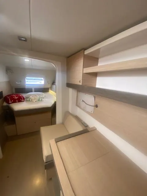 Slide: The Image of Interior of 2017 Bali 4.0 yacht with modern wooden cabinetry and cozy sleeping area. - 14