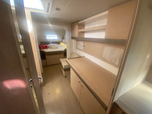 Slide: The Image of Interior cabin of a 2017 Bali 4.0 catamaran with bed and storage. - 15