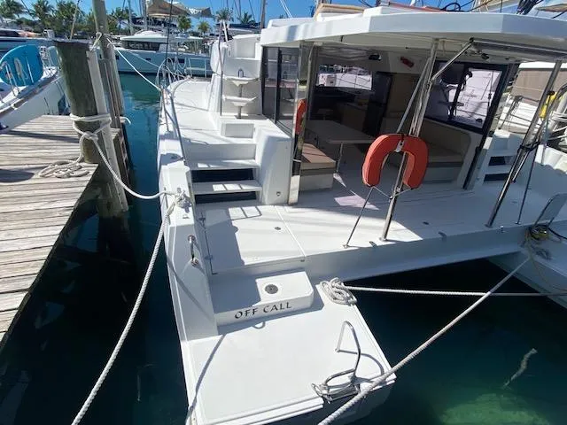 Slide: The Image of 2017 Bali 4.0 catamaran docked at marina, rear view with open deck. - 2