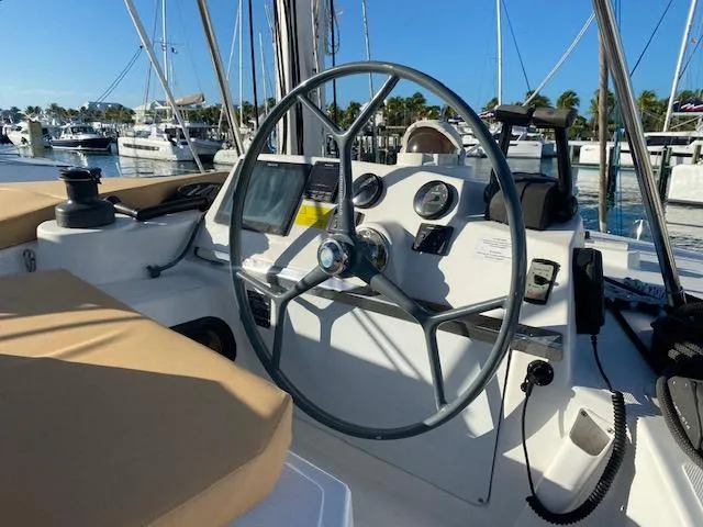 Slide: The Image of Helm of 2017 Bali 4.0 catamaran at marina, featuring navigation instruments and steering wheel. - 3
