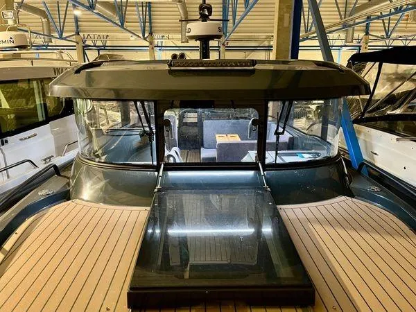Slide: The Image of 2024 XO Boats EXPLR 10S, interior view, docked in a marina. - 8