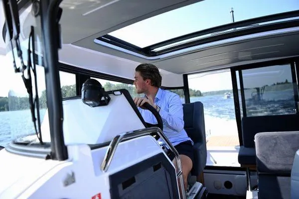 Slide: The Image of Man steering 2024 XO Boats EXPLR 10S on a sunny day. - 10