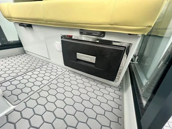 Slide: The Image of Interior of 2024 XO Boats DFNDR 9 with Dometic fridge and hexagonal floor design. - 13