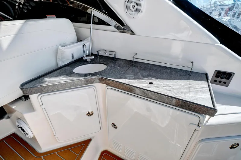 Slide: The Image of 2006 Regal 3560 Commodore yacht interior kitchenette with sink and storage. - 10