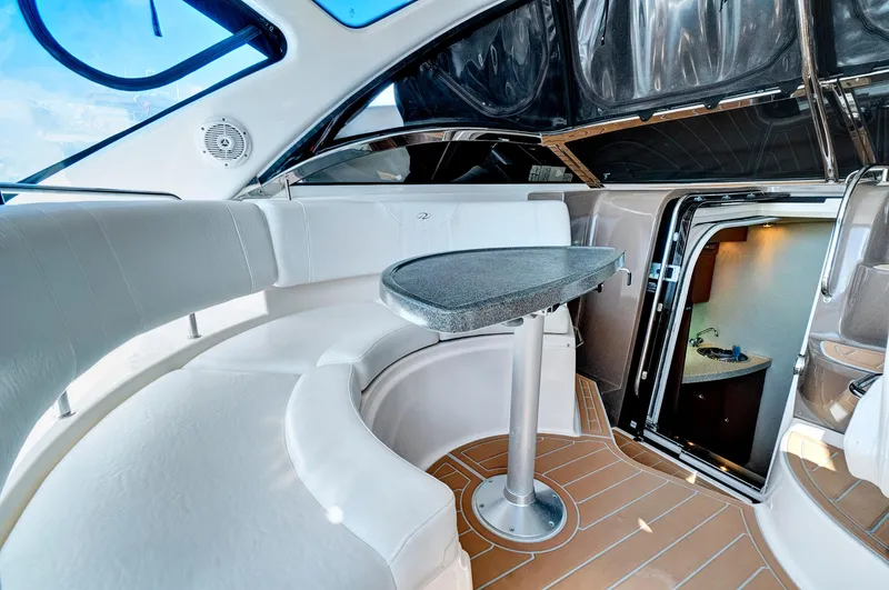 Slide: The Image of Interior of 2006 Regal 3560 Commodore yacht with white seating and table. - 13