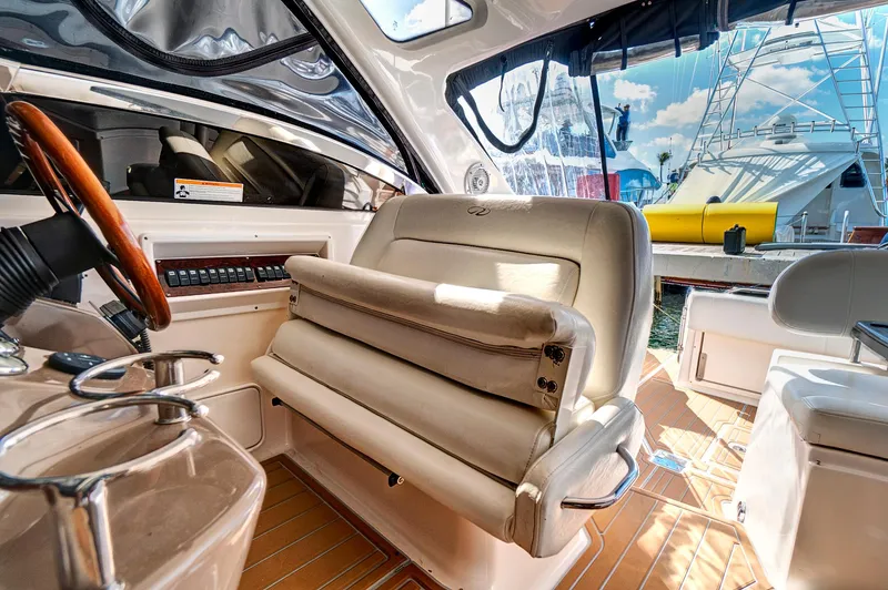 Slide: The Image of Interior of 2006 Regal 3560 Commodore yacht with helm seat and dashboard. - 14