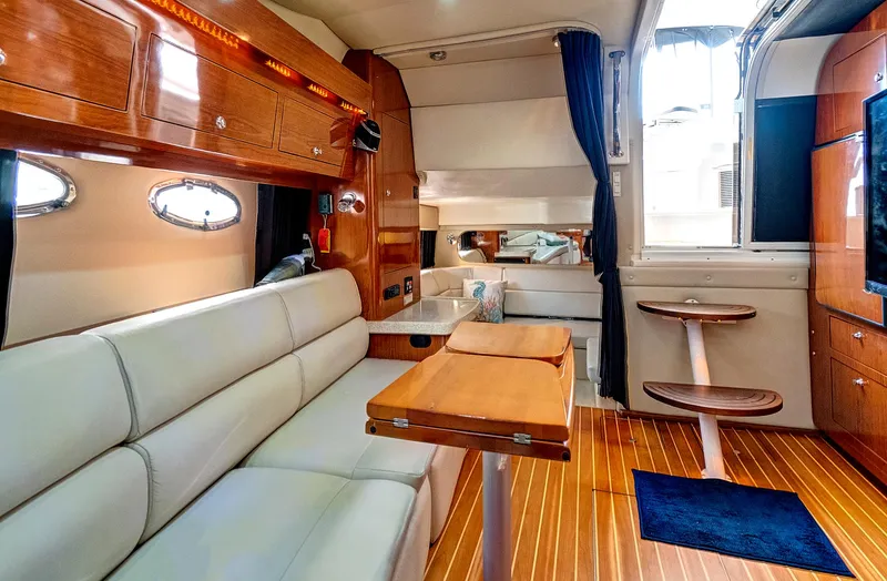 Slide: The Image of Luxurious interior of 2006 Regal 3560 Commodore yacht with wooden finishes and white seating. - 20