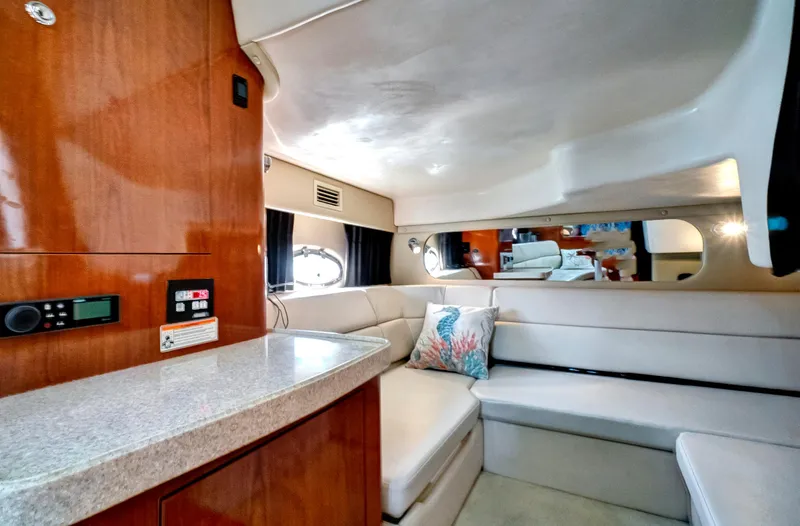 Slide: The Image of Interior of 2006 Regal 3560 Commodore yacht with modern seating and wooden cabinetry. - 21