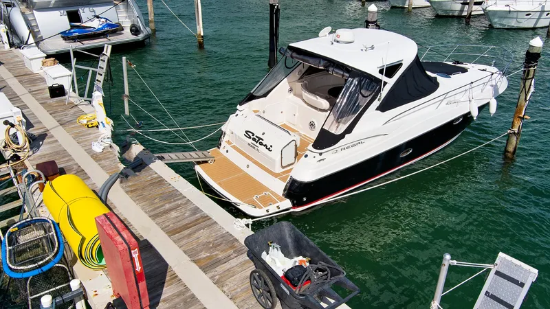 Slide: The Image of 2006 Regal 3560 Commodore yacht docked at marina. - 6