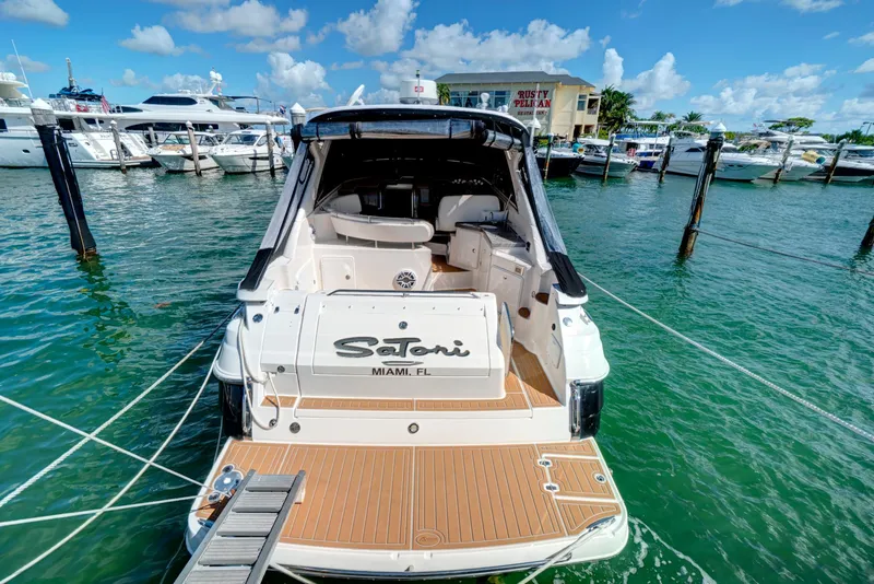 Slide: The Image of 2006 Regal 3560 Commodore yacht docked in marina with open cockpit. - 9