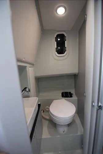 Slide: The Image of 2024 XO Boats DFNDR 9 bathroom with toilet and sink. - 6