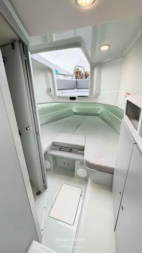 Slide: The Image of Interior cabin of 2024 XO Boats DFNDR 9 with modern design and ample seating. - 8