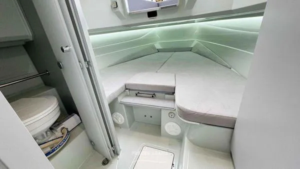 Slide: The Image of 2024 XO Boats DFNDR 9 cabin interior with bed and toilet. - 9