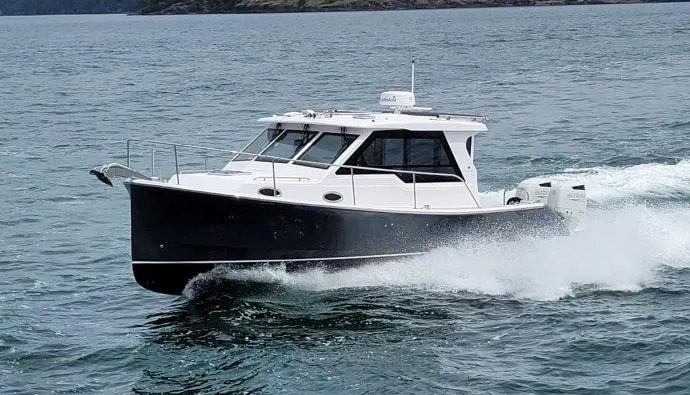 Slide: The Image of 2024 True North 34 boat cruising on open water. - 0