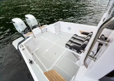 Slide: The Image of 2024 True North 34 boat deck with twin outboard motors and striped seating. - 15