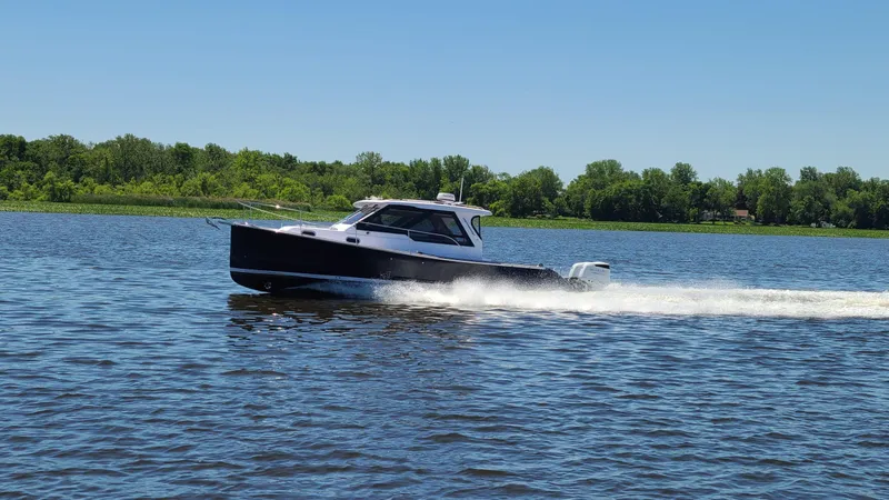 Slide: The Image of 2024 True North 34 boat cruising on a lake. - 22