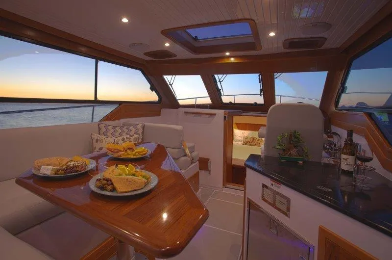 Slide: The Image of Luxurious interior of 2024 True North 34 yacht with dining area and ocean view. - 3