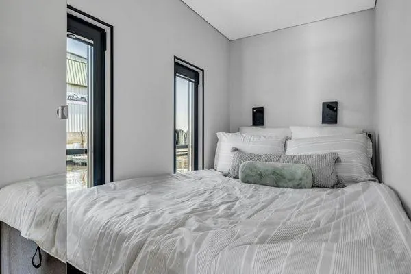 Slide: The Image of Compact bedroom in La Mare Modern 11 house model, 2024, with minimalist design and natural light. - 12