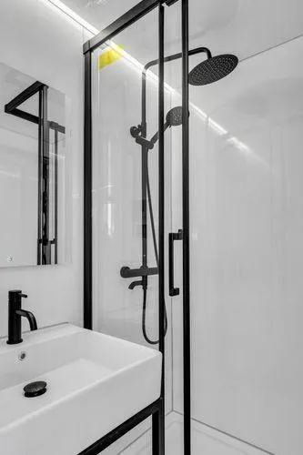 Slide: The Image of 2024 La Mare Modern 11 bathroom with sleek black shower and white sink. - 15