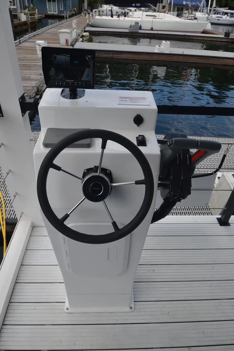 Slide: The Image of Steering console of a 2024 La Mare Modern 11 boat at a marina. - 30
