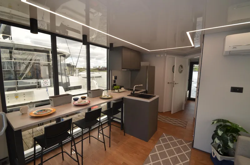 Slide: The Image of Modern kitchen interior of La Mare Modern 11 houseboat, 2024 model, with sleek design and waterfront view. - 8