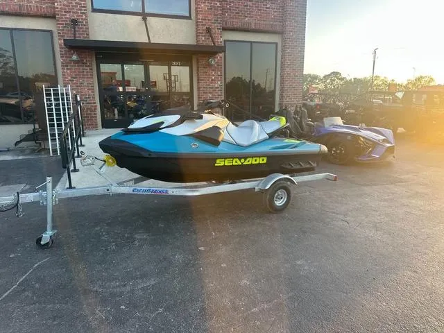 Slide: The Image of 2024 Sea-Doo Waverunner GTI on trailer outside a brick building. - 3