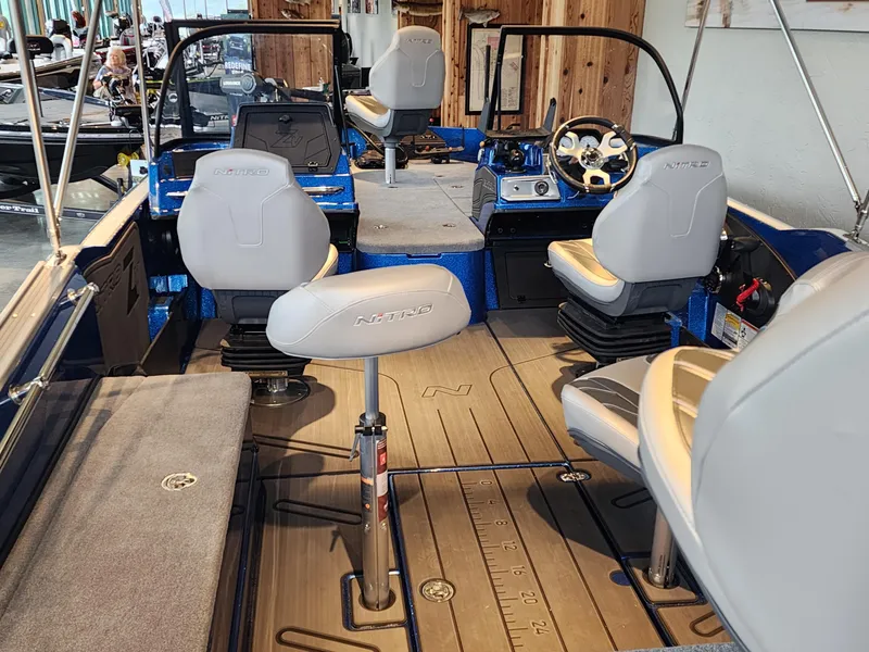 Slide: The Image of 2024 Nitro ZV21 fishing boat interior with seating and control console. - 3